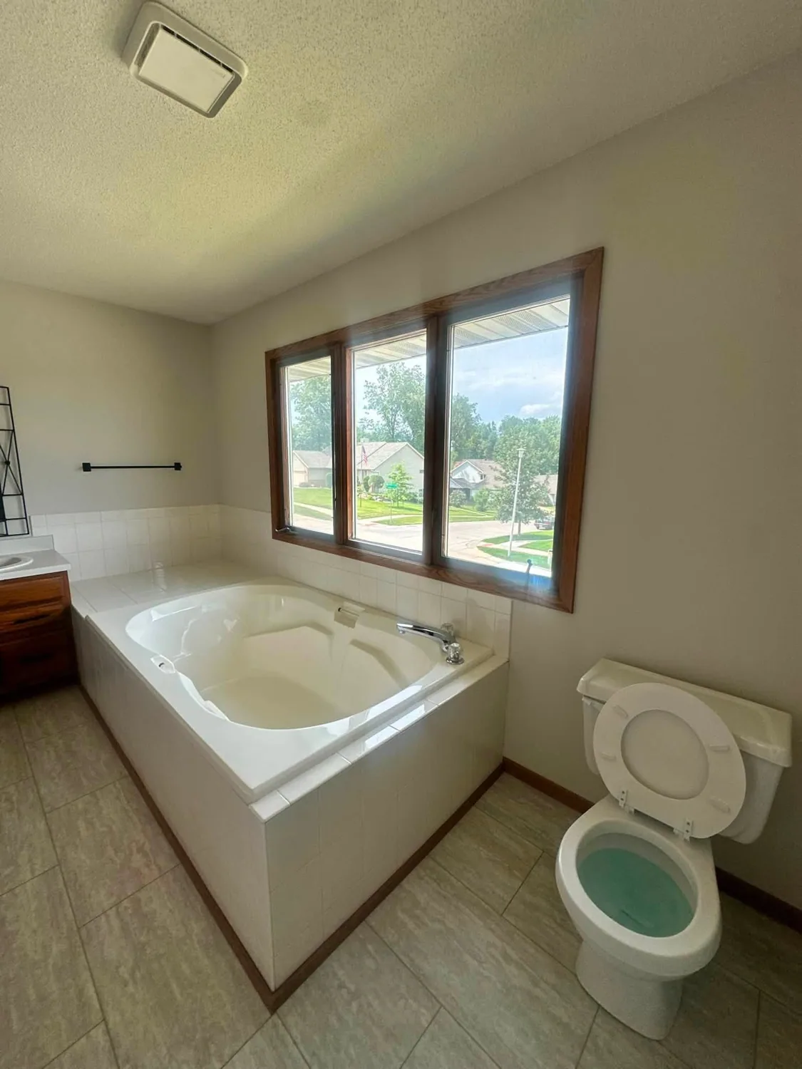 White bathtub and cleaned tile floor